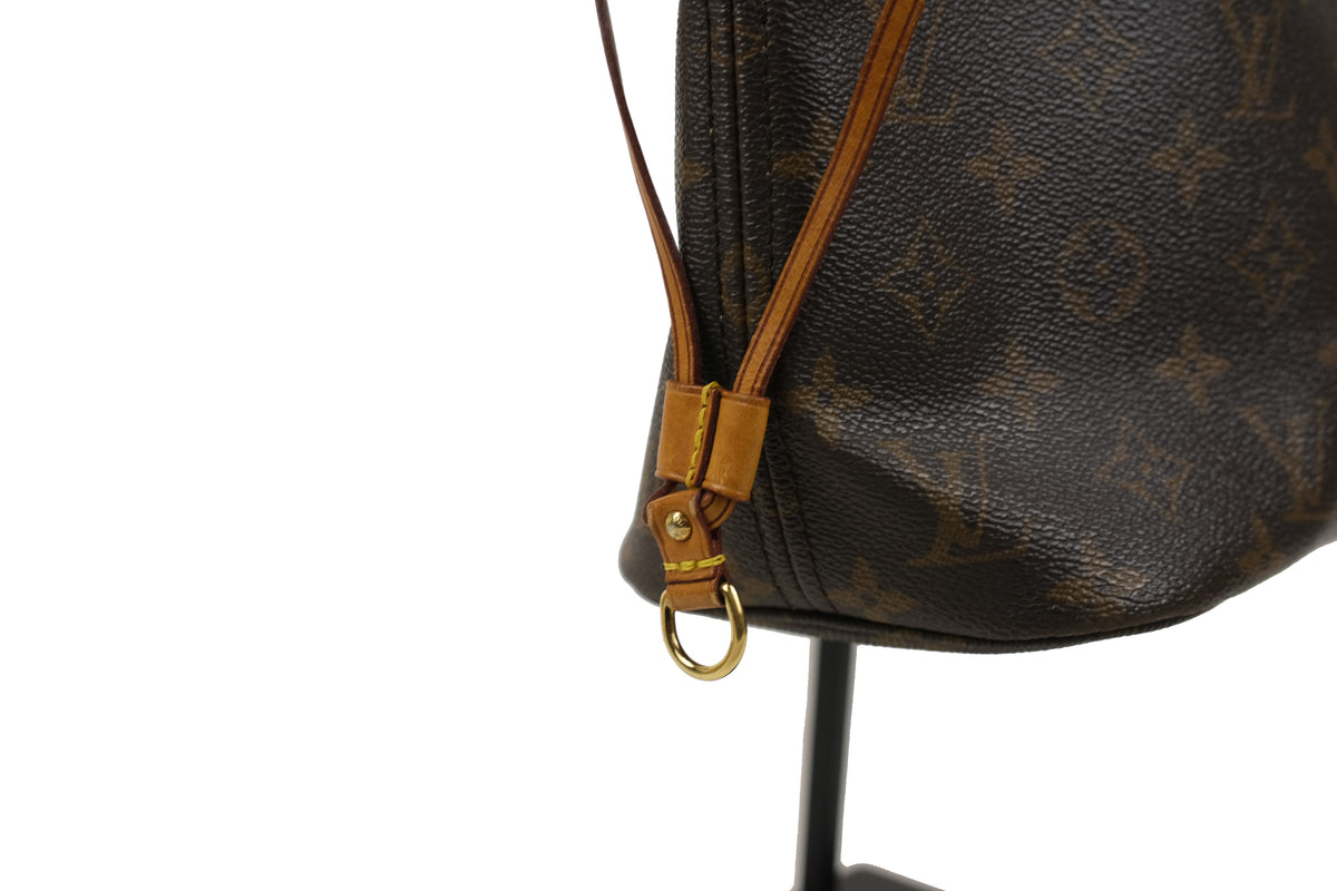 Close-up of the tan handles on the Louis Vuitton Monogram Neverfull PM tote