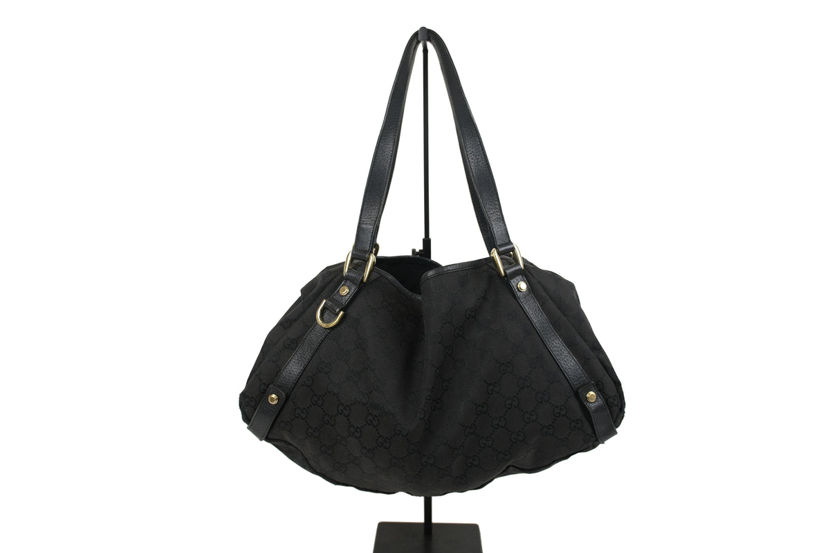 Black Gucci GG Canvas Abbey tote with long leather shoulder straps and gold-tone details, front view