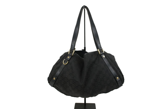 Black Gucci GG Canvas Abbey tote with long leather shoulder straps and gold-tone details, front view